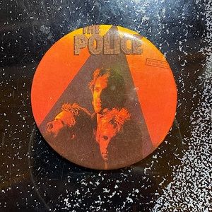 The police Zenyatta Mondatta lapel pin